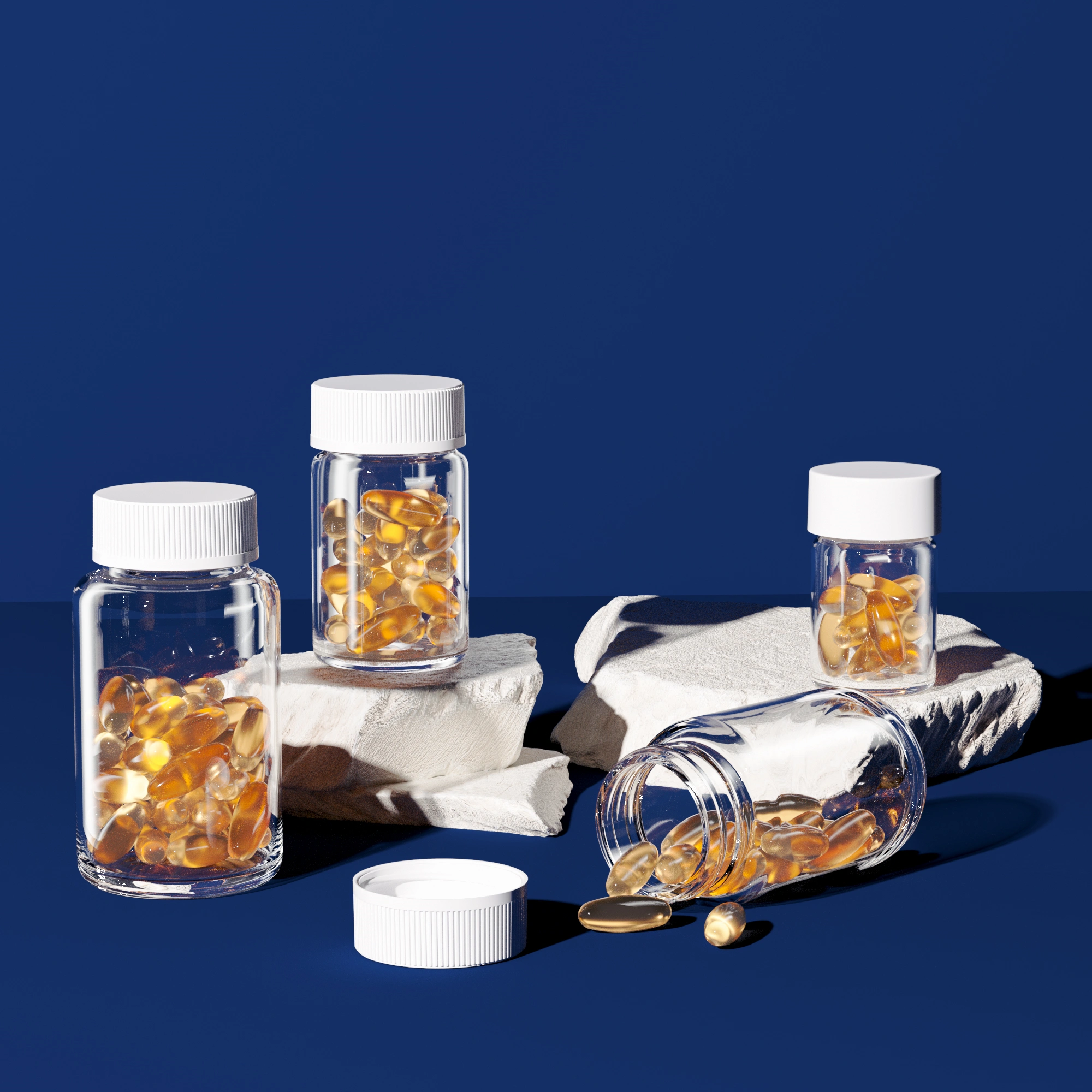 Clear PETG supplement bottles with white caps filled with amber omega-3 softgel capsules, one bottle tipped over spilling softgels onto a blue surface — Jarsking nutraceutical packaging