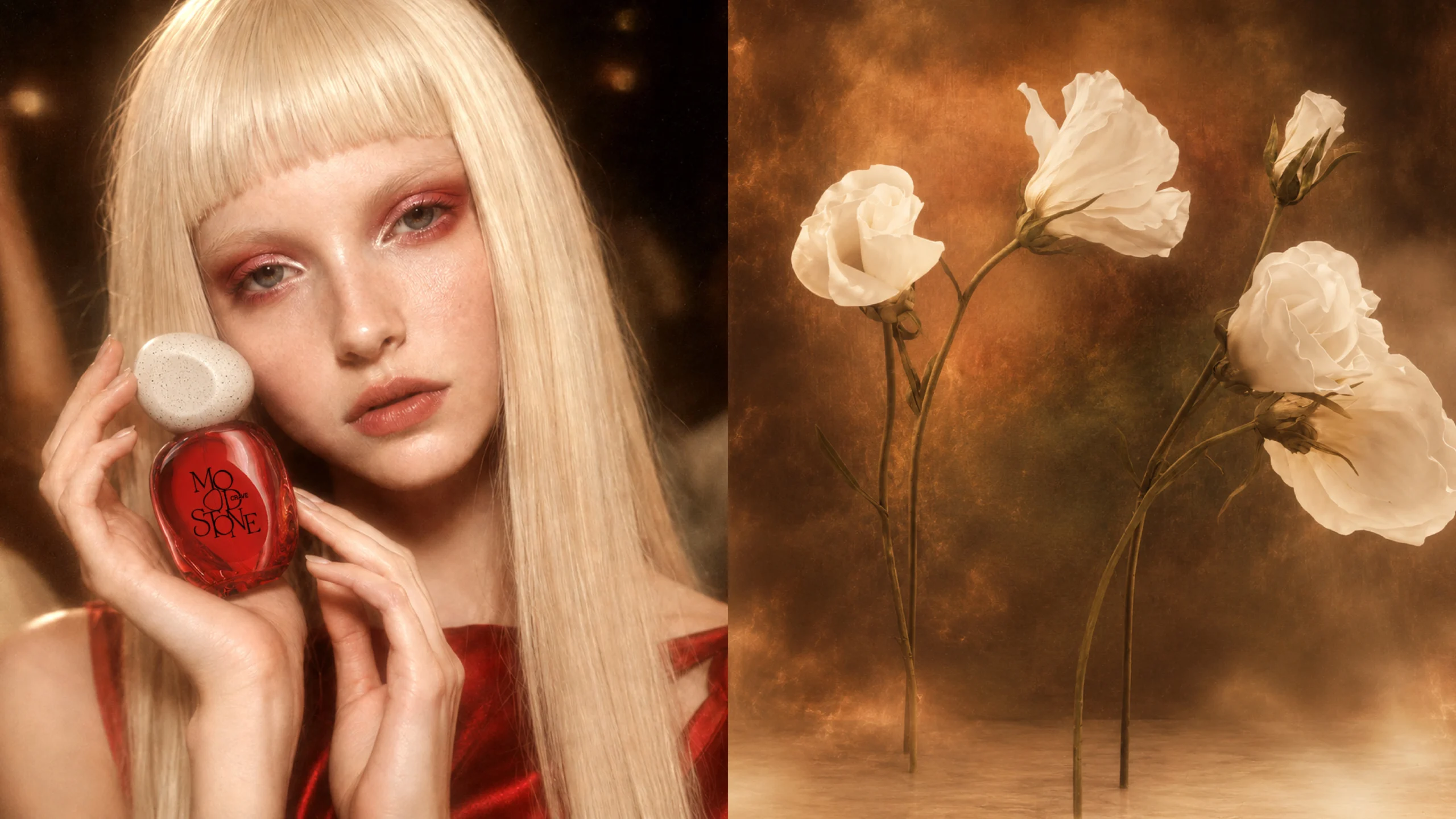 model holding a translucent coral-red MOOD//STONE CRAVE perfume bottle with a white speckled pebble cap beside white flowers